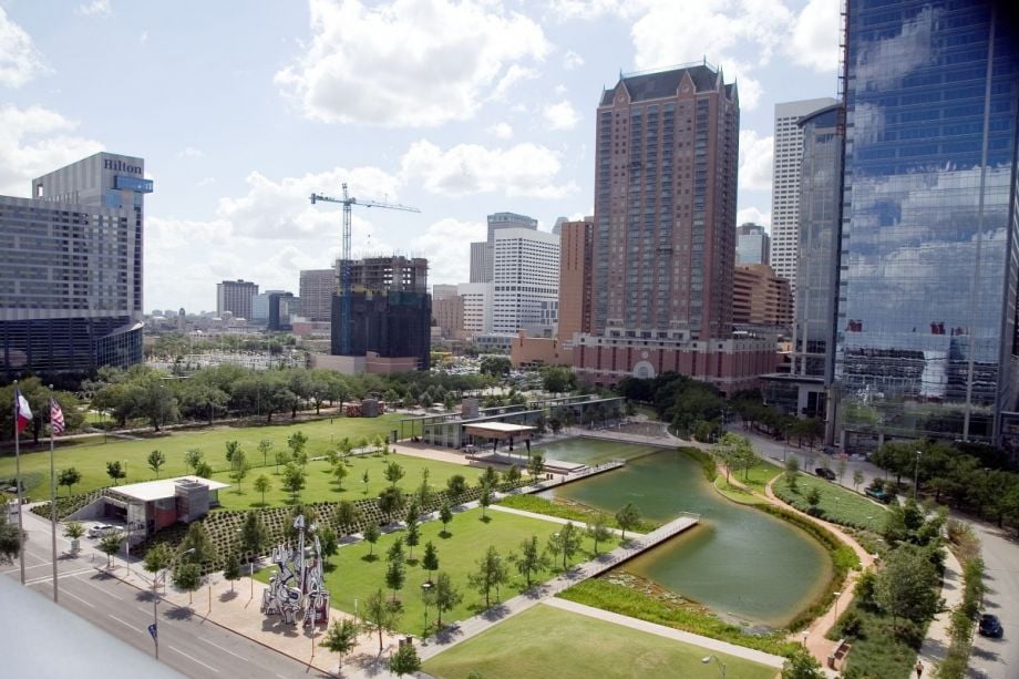 Skyscrapers in downtown Houston overlooking a public green space.