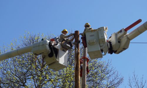 Crew members replace a utility pole in Massena, New York.