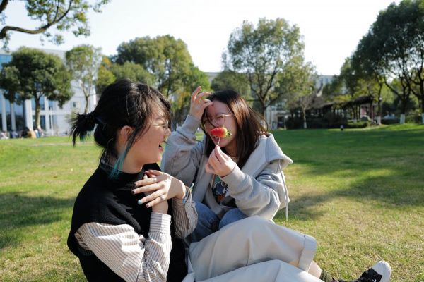 Two Asian American girls laughing together.