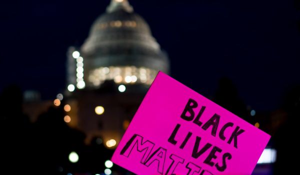 A protestor holds a Black Lives Matter sign during a rally from the White House to the Capitol, July 8, 2016.