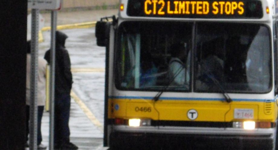 A person boarding an MBTA bus in Boston