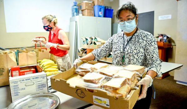 woman with box of sandwiches at food bank