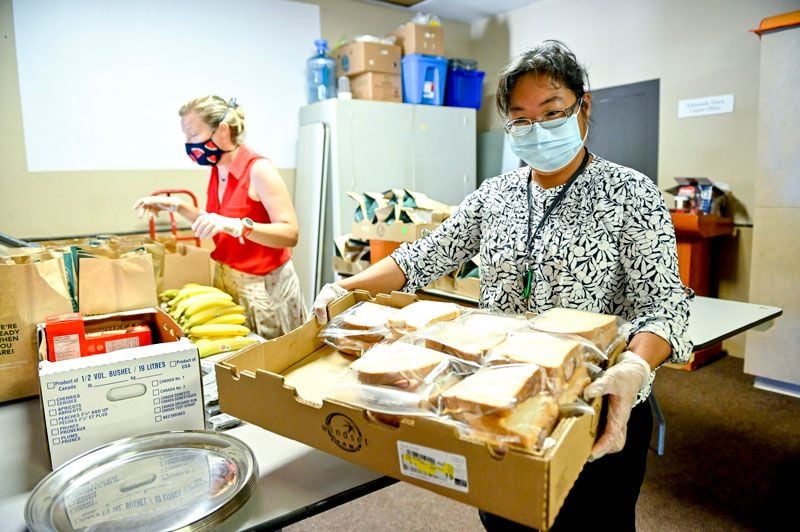 woman with box of sandwiches at food bank 