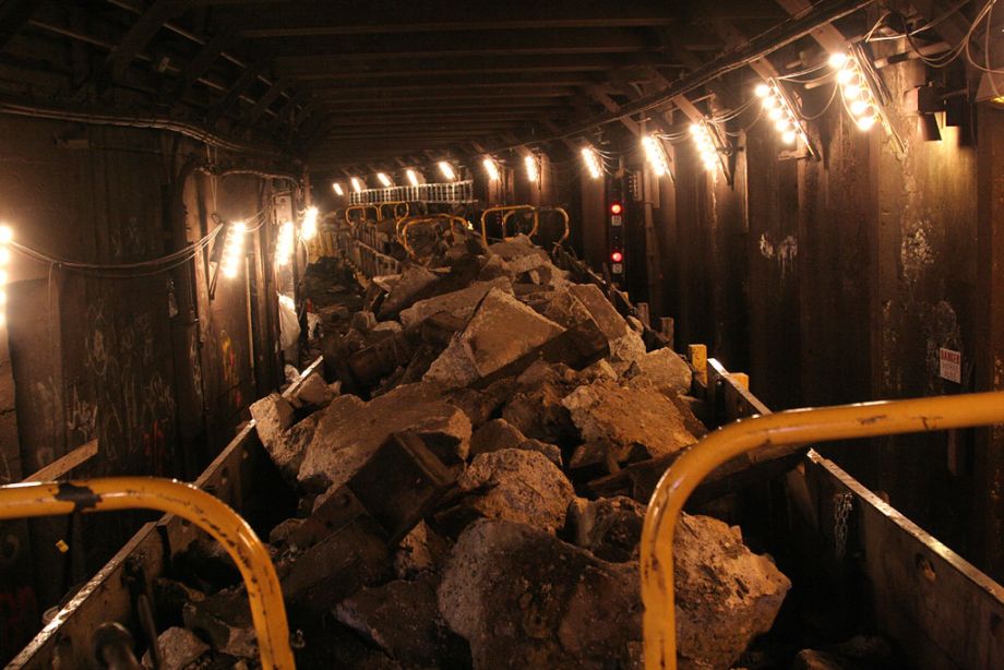 Concrete debris being removed from a subway tunnel