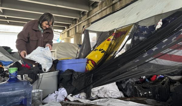 Candice Allison, 63, sorts through her possessions on Jan. 15, 2025, after Louisiana state authorities ordered her and others to leave an encampment near the stadium where New Orleans will host the Super Bowl next month.