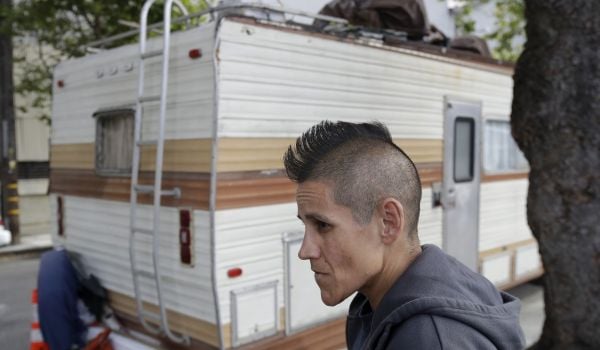 This Thursday, June 27, 2019, file photo shows Shanna Couper Orona interviewed outside of her RV parked along a street in San Francisco. The number of people living in RVs or cars in November 2021 increased 22% over January 2020.