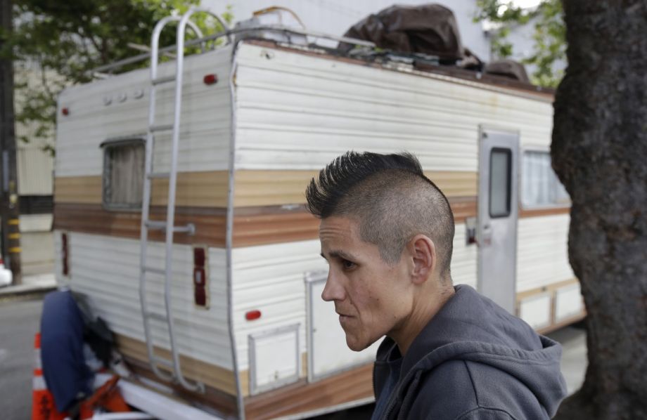 This Thursday, June 27, 2019, file photo shows Shanna Couper Orona interviewed outside of her RV parked along a street in San Francisco. The number of people living in RVs or cars in November 2021 increased 22% over January 2020. 