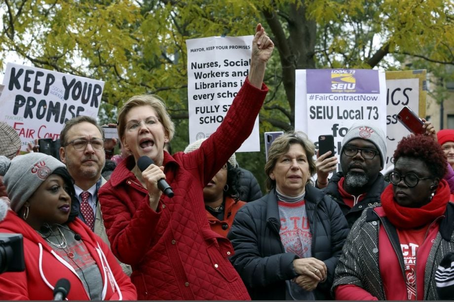 Democratic presidential candidate Elizabeth Warren calls for people across the country to support striking Chicago teachers after joining educators picketing outside an elementary school, Tuesday, Oct. 22, 2019, in Chicago. (AP Photo/Teresa Crawford)