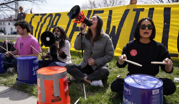 Protesters chant and use buckets as drums during demonstration