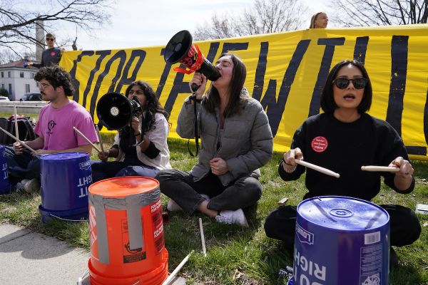 Protesters chant and use buckets as drums during demonstration