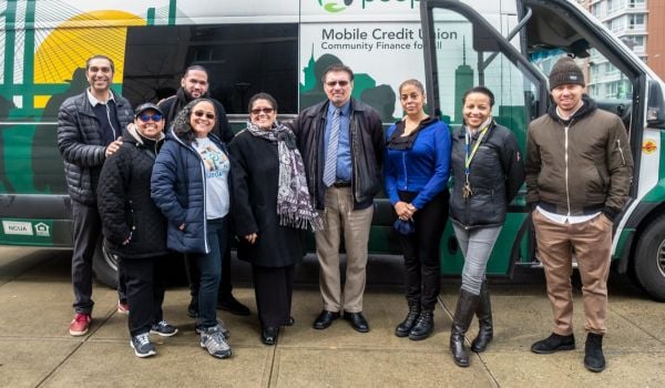 Bronx Financial Access Coalition members stand in front of their mobile bank van