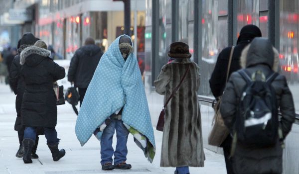 A homeless man bundles up in downtown Chicago.