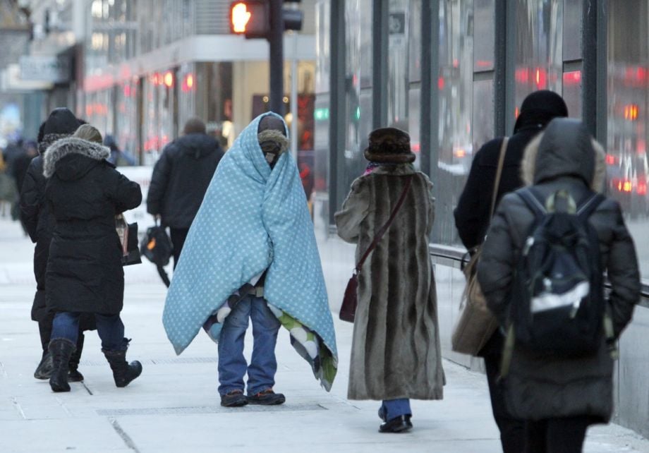 A homeless man bundles up in downtown Chicago.