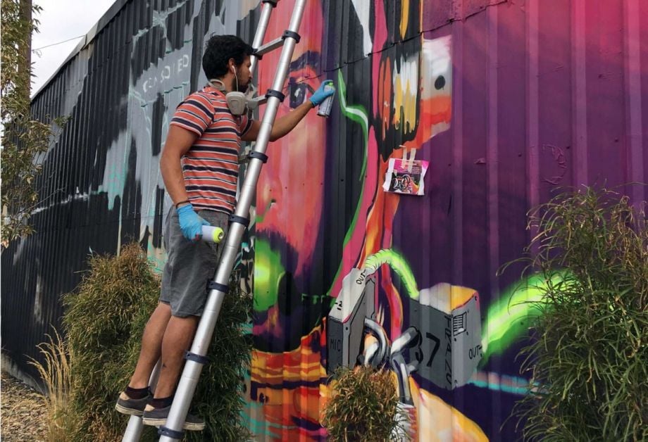 Artist Chris Fonseca installing a mural in the Live-Work-Create District in Garden City, Idaho.