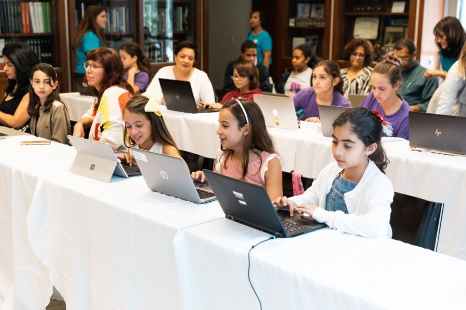 Girls using computers in a Code/Art session to teach coding and STEM skills