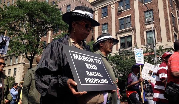 People march in a rally to end racial profiling