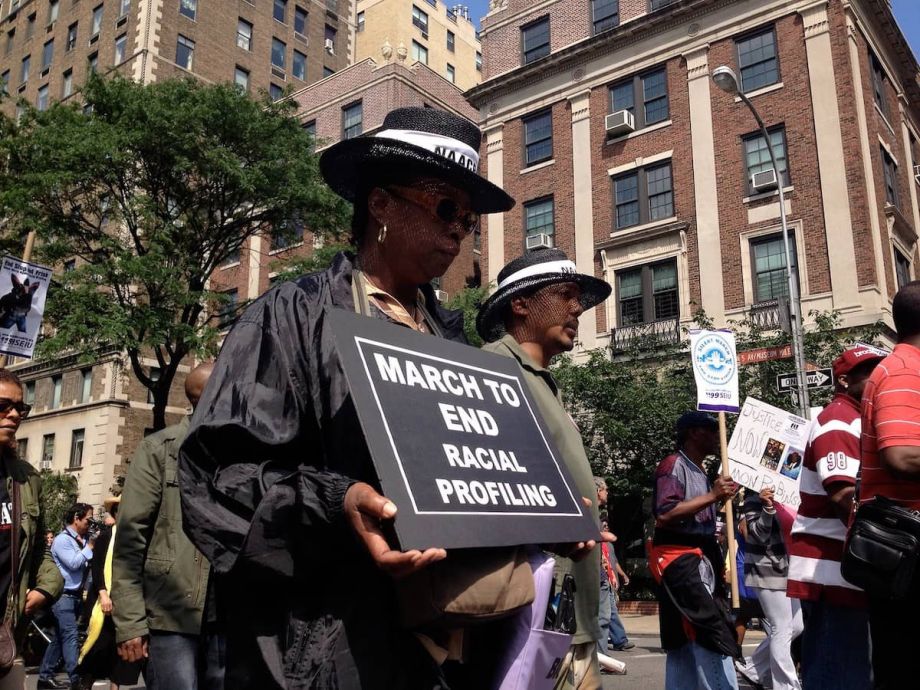People march in a rally to end racial profiling