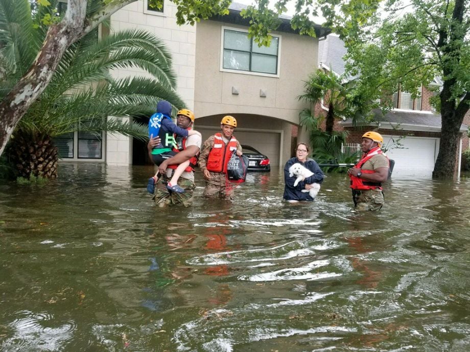 Residents leave their homes amid floods.