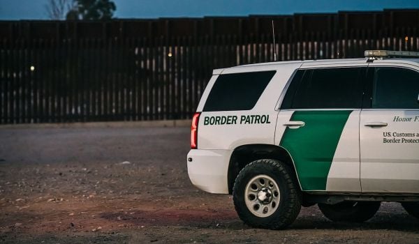 White and green Border Patrol vehicle near U.S. border
