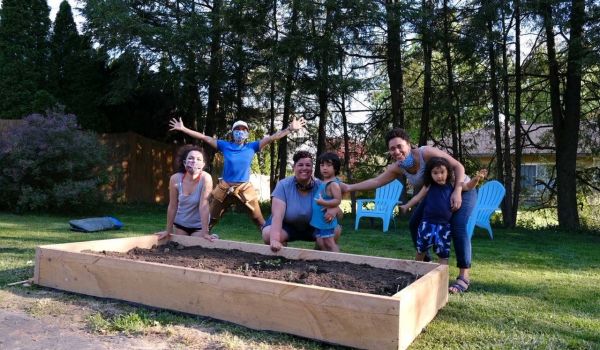 Meadow Braun and her family after getting her raised bed installed by Soul Fire in the City