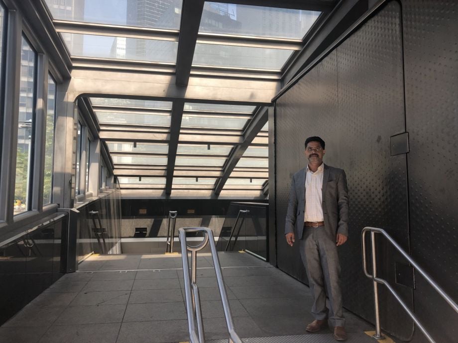 Projjal Dutta, director of sustainability initiatives for the MTA, stands in front of one of his resiliency efforts at a Manhattan subway station. 