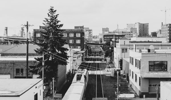Industrial district in Portland, Oregon; train moves through rows of buildings on either side