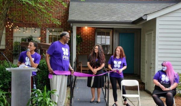 Founder and CEO of Promise Resource Network Cherene Allen-Caraco, center, at the ribbon-cutting ceremony for the mental health agency's peer-run respite.