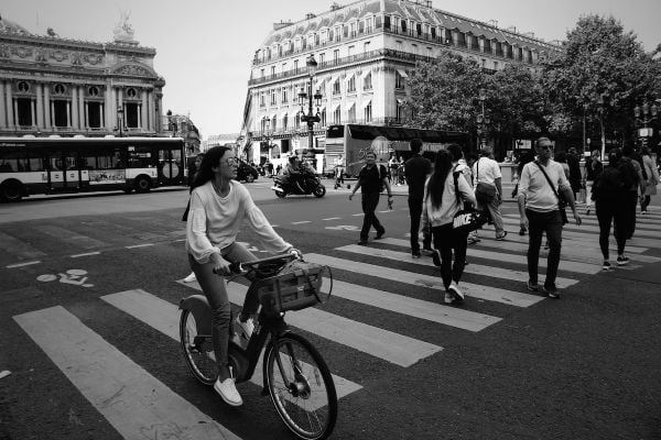 People crossing the street in a famous square (Place de l'Opéra) in Paris