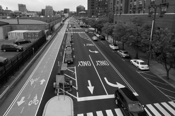 Aerial view of a street in Hoboken with lanes for vehicles, parking spots and protected bike lanes