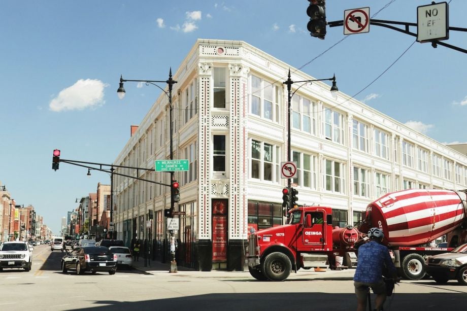 an image of a chicago intersection with heavy traffic including cars and a concrete truck 