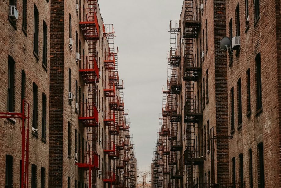 Rows of brick apartments with fire escapes