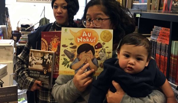 Lily Prijoles (center front) and Golda Sargento, owners of Arkipelago Bookstore (also baby Miles in front).