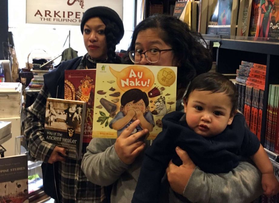 Lily Prijoles (center front) and Golda Sargento, owners of Arkipelago Bookstore (also baby Miles in front). 
