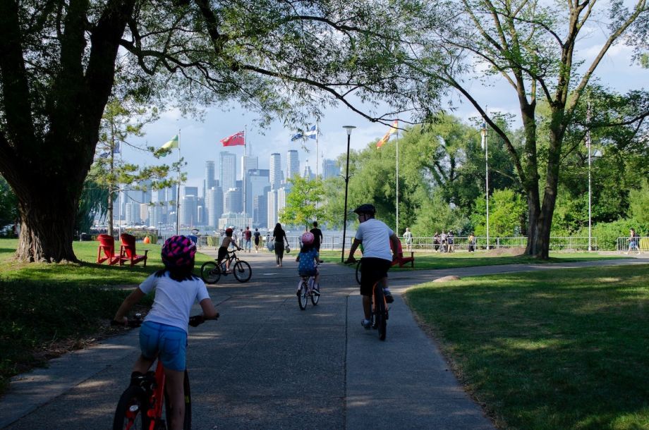 Family biking through a park