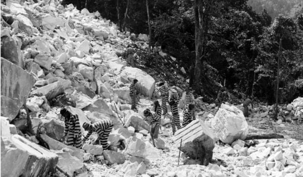 Incarcerated people work in a rock quarry, possibly Keith Quarry near Palmetto, Georgia, around 1948.