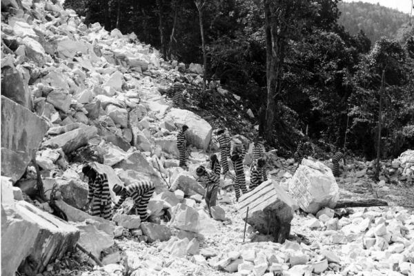 Incarcerated people work in a rock quarry, possibly Keith Quarry near Palmetto, Georgia, around 1948.
