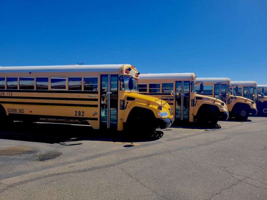 Row of buses in parking lot