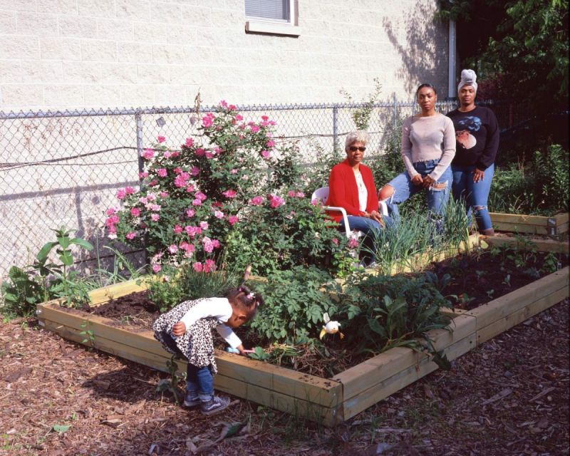Gina Jamison and her daughter and granddaughters pose at the community garden of Garfield Park, Chicago, on June 2, 2021.