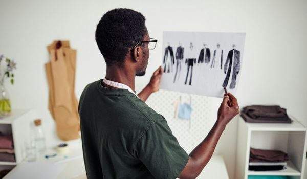 Young Black man designing clothing