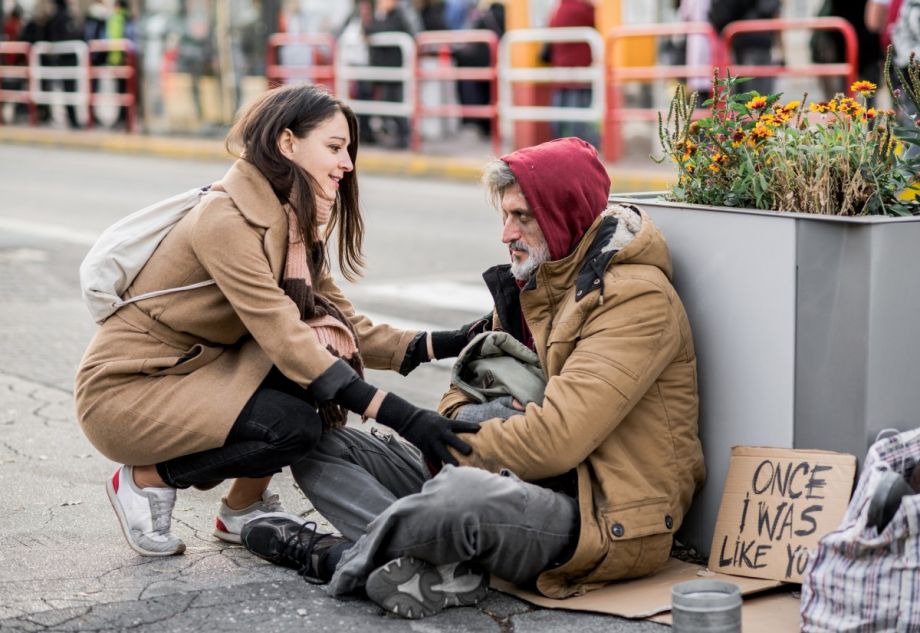 Woman speaking with a person experiencing homelessness