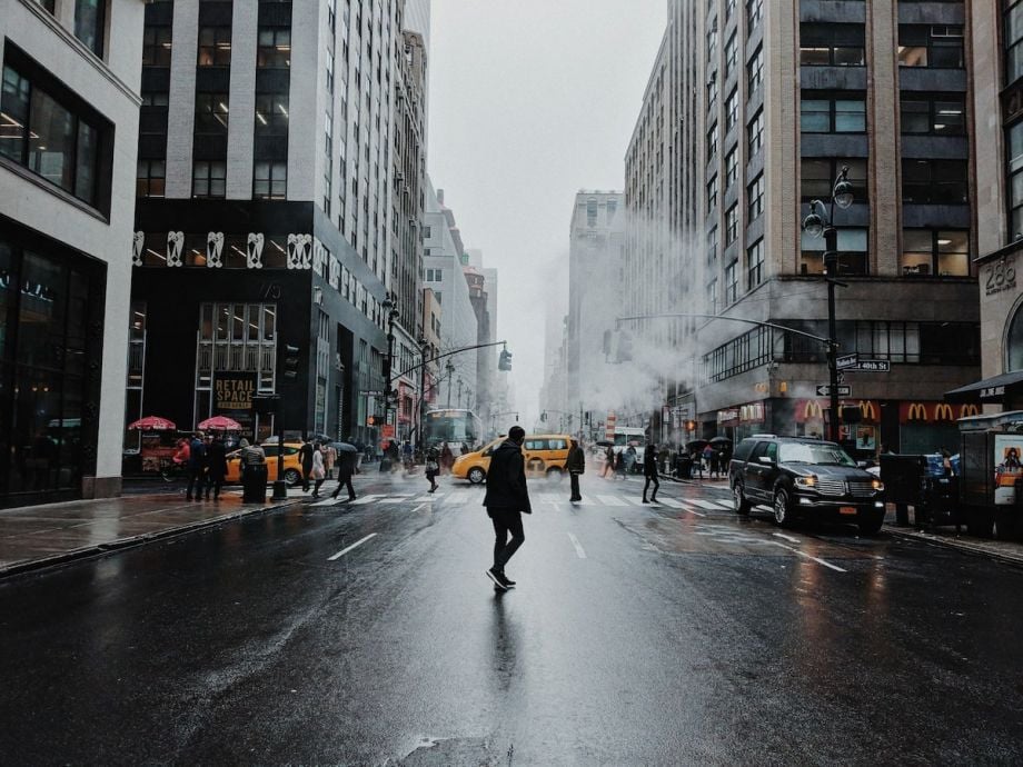 Person jaywalking across a street in New York City