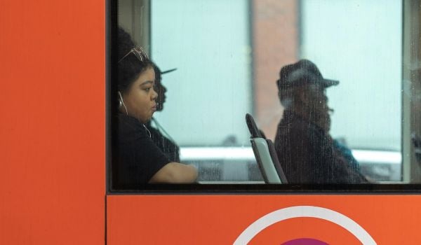 A woman riding on public transportation.