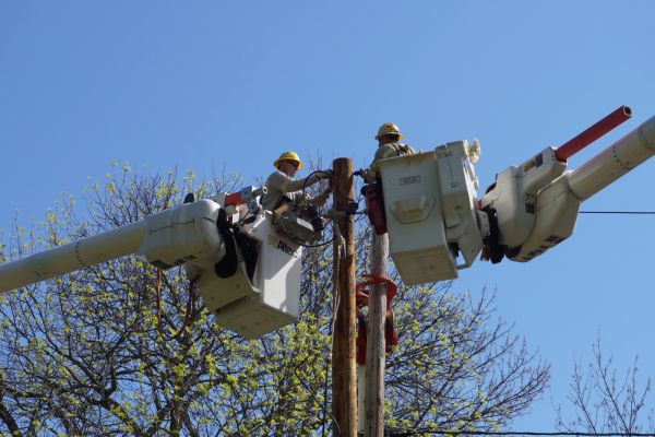 Crew members replace a utility pole in Massena, New York.