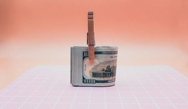 Hundred dollar bills folders with a clothes line clip holding them together