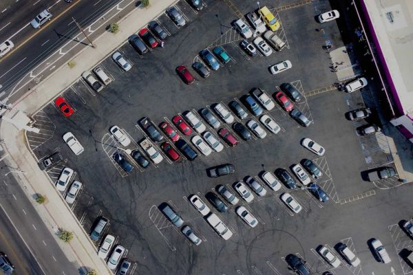 Aerial view of a parking lot in front of a 99 cent store
