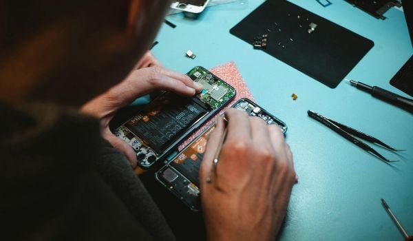 Back-sde view of someone repairing a phone