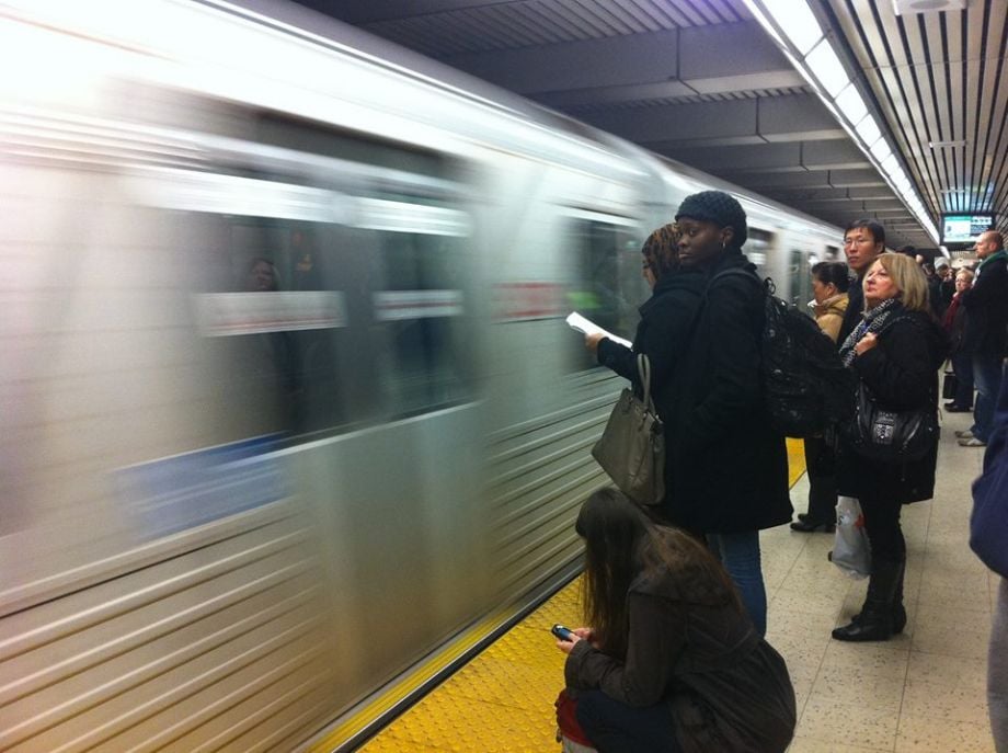 passengers wait to board a subway in Toronto