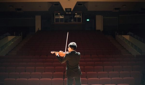 A violinist in an empty music hall